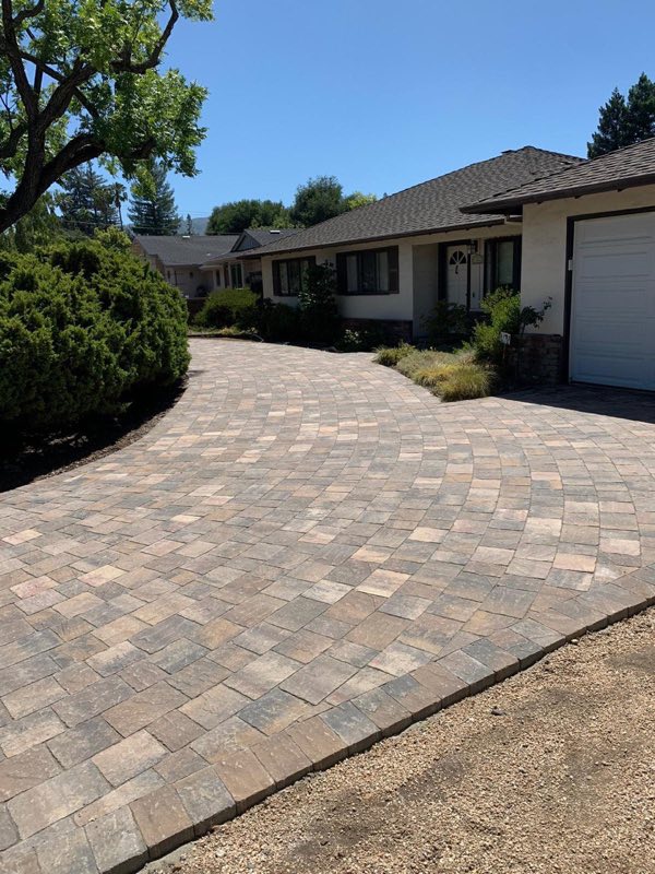 Paver driveway leading up to a home